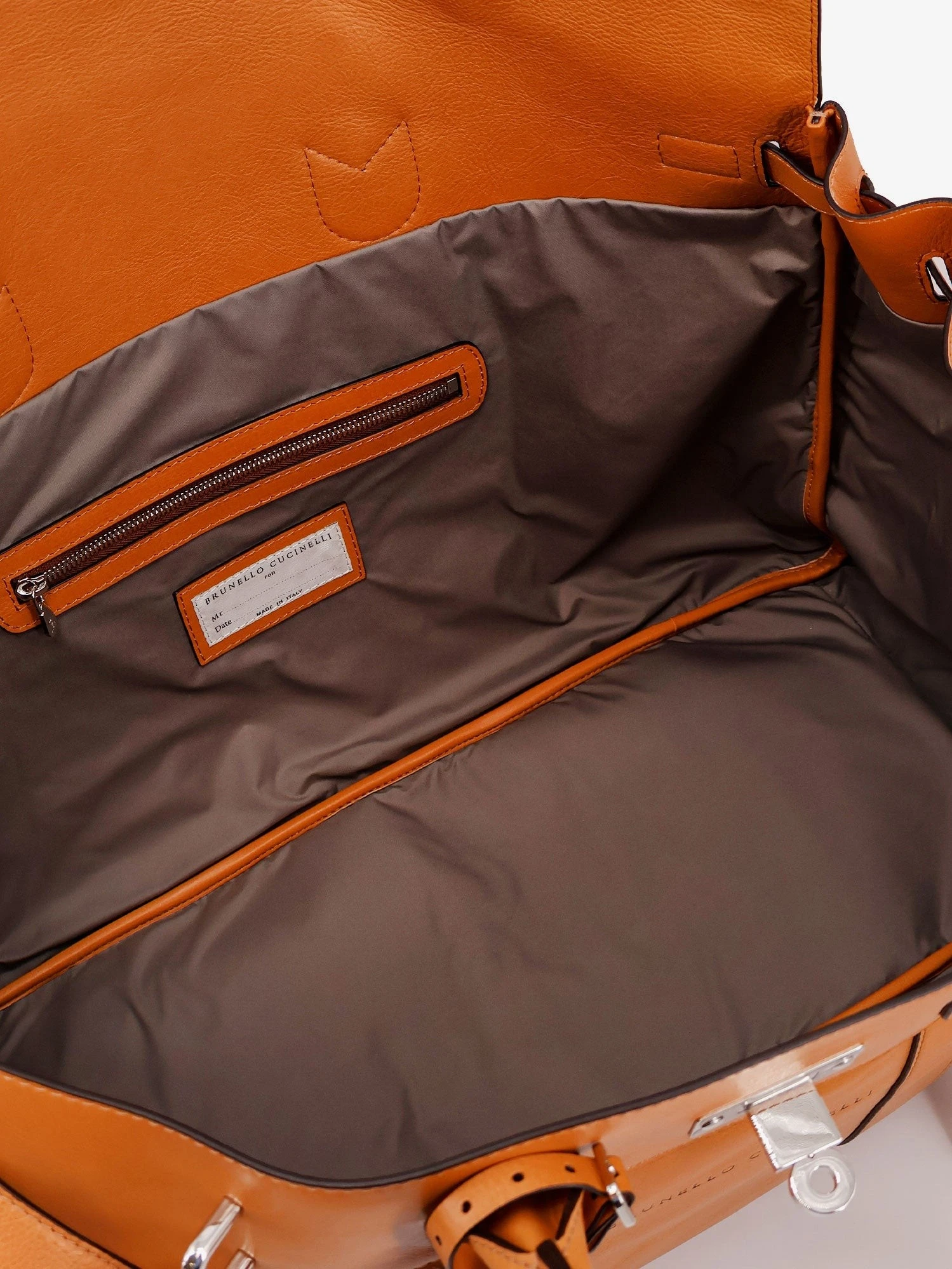 Leather travel bag with engraved logo on the front.webp