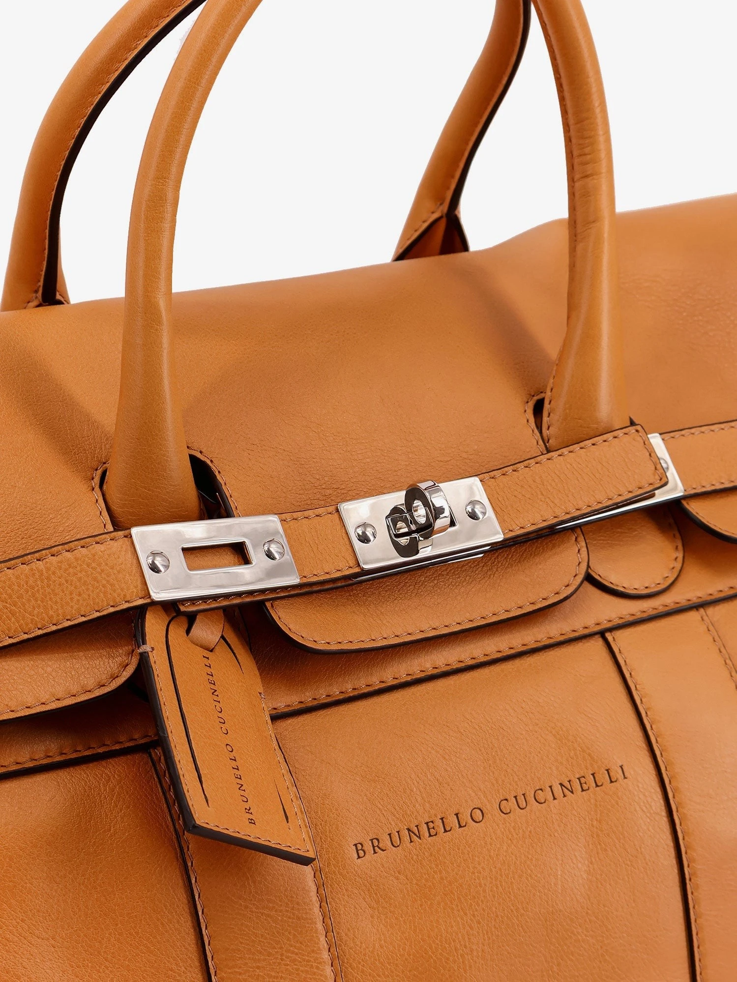 Leather travel bag with engraved logo on the front.webp