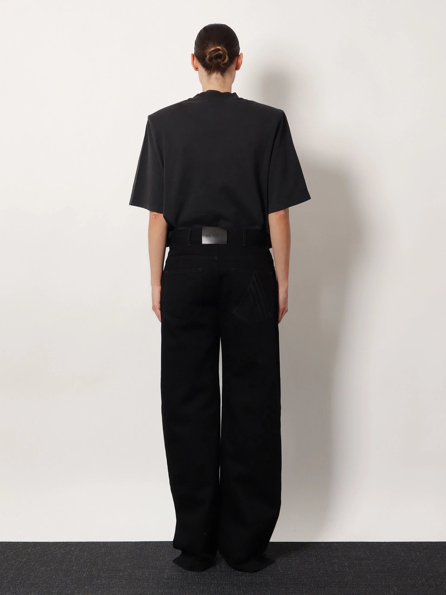 Black denim trousers.webp