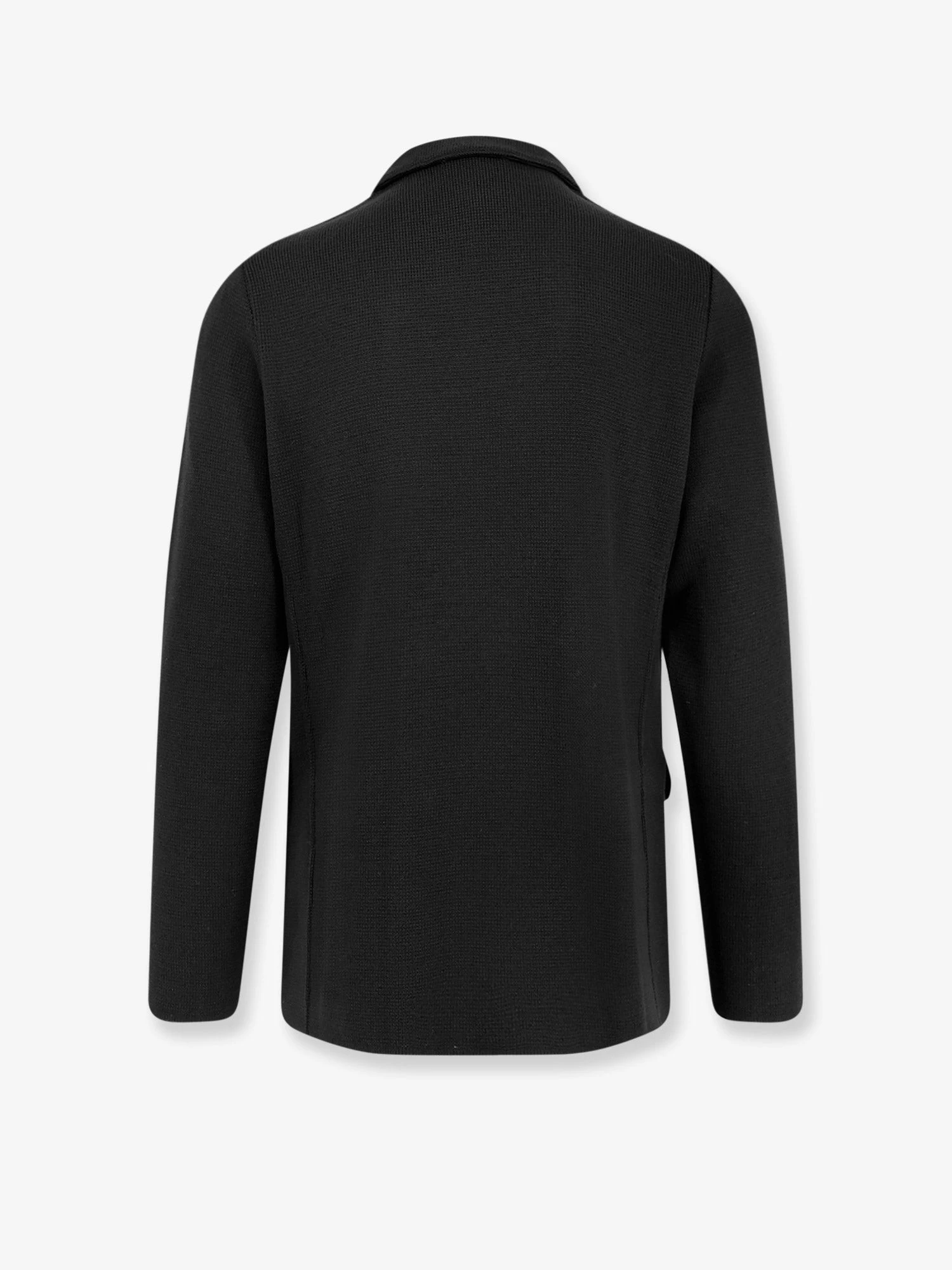 Knitted blazer with iconic brooch.webp