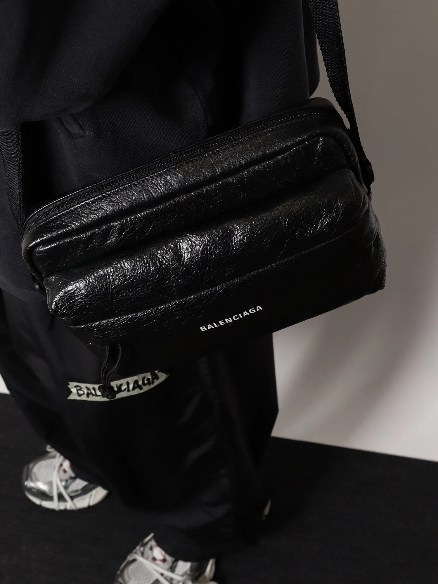 Leather crossbody bag with logo on the front.webp