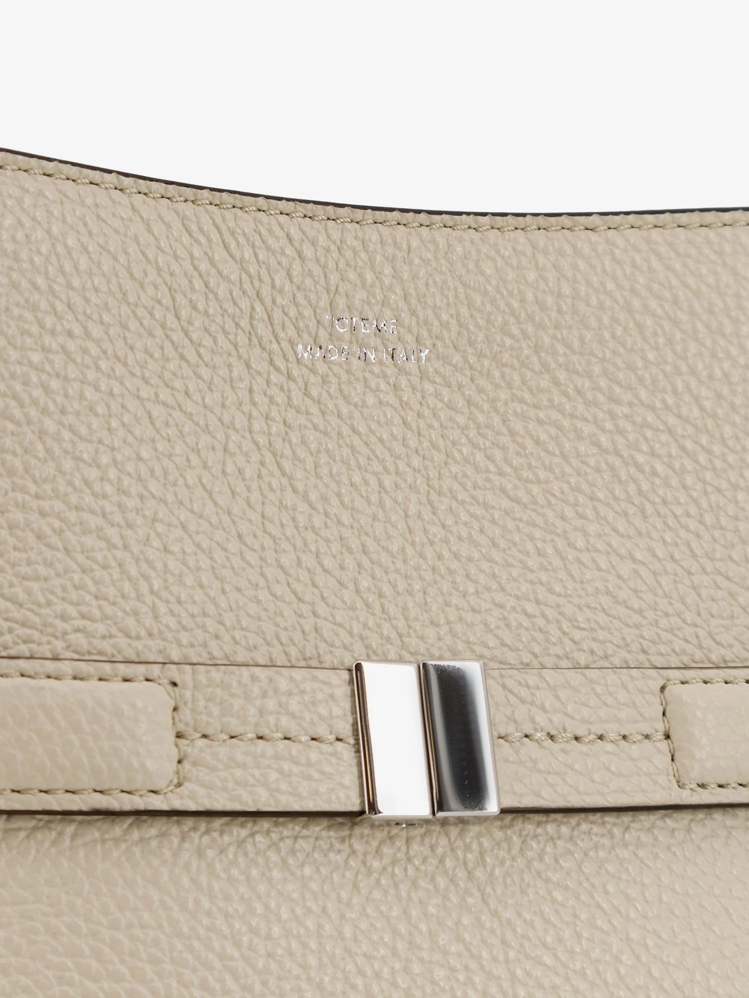 Hammered leather bucket bag with strap on the front.webp