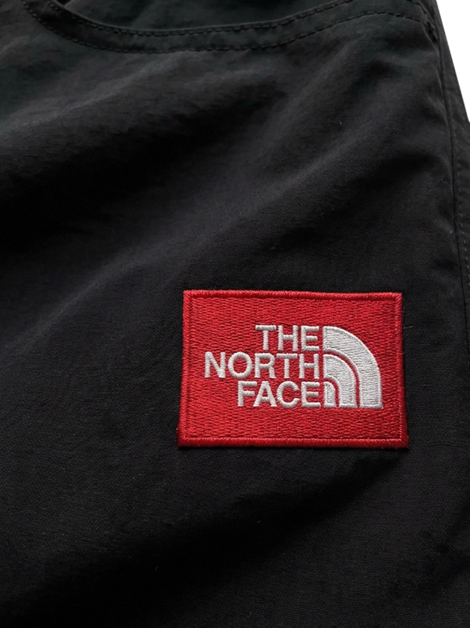 Nylon trousers with front logo patch.webp