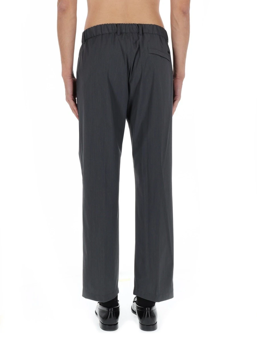 Wide-brimmed hat with metal logo on the front.webp