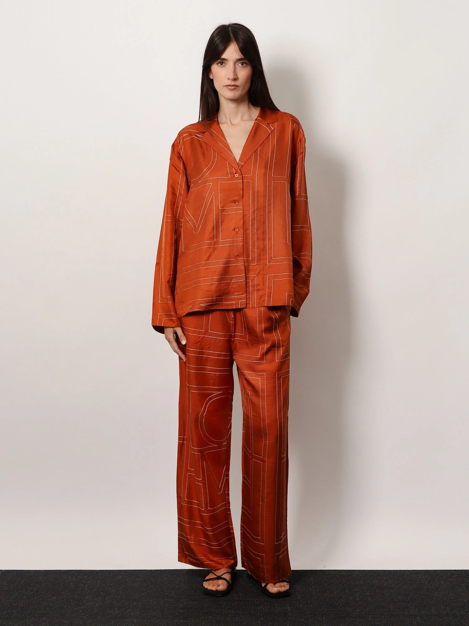 Silk trousers with monogram logo embroidery.webp