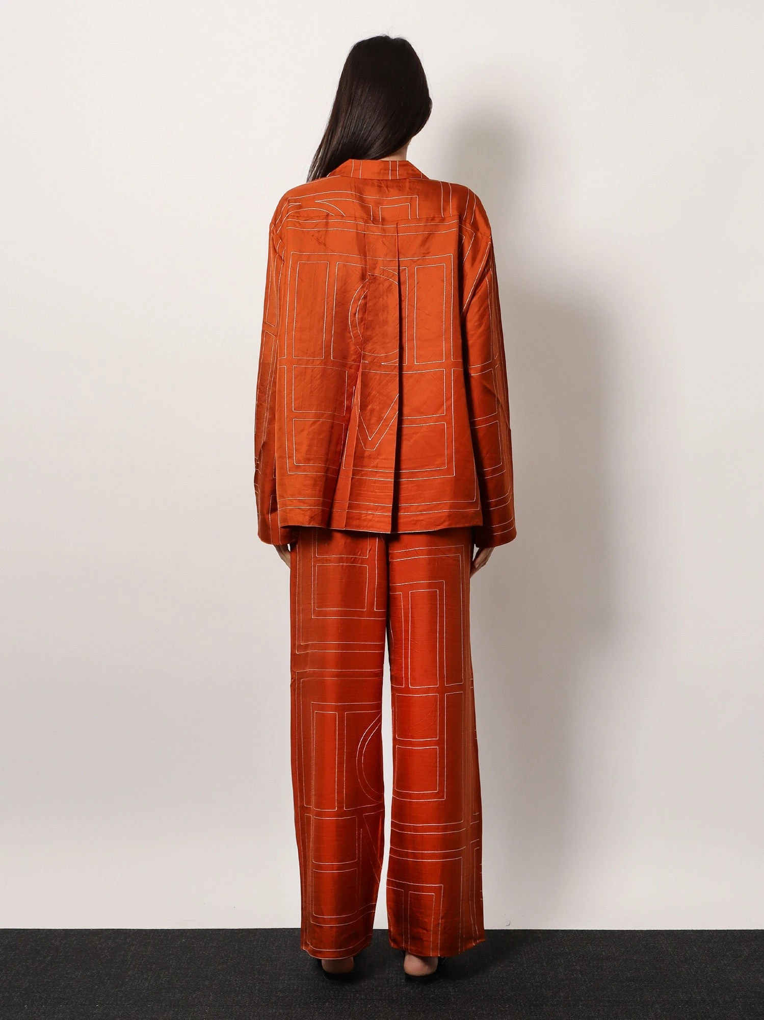 Silk trousers with monogram logo embroidery.webp