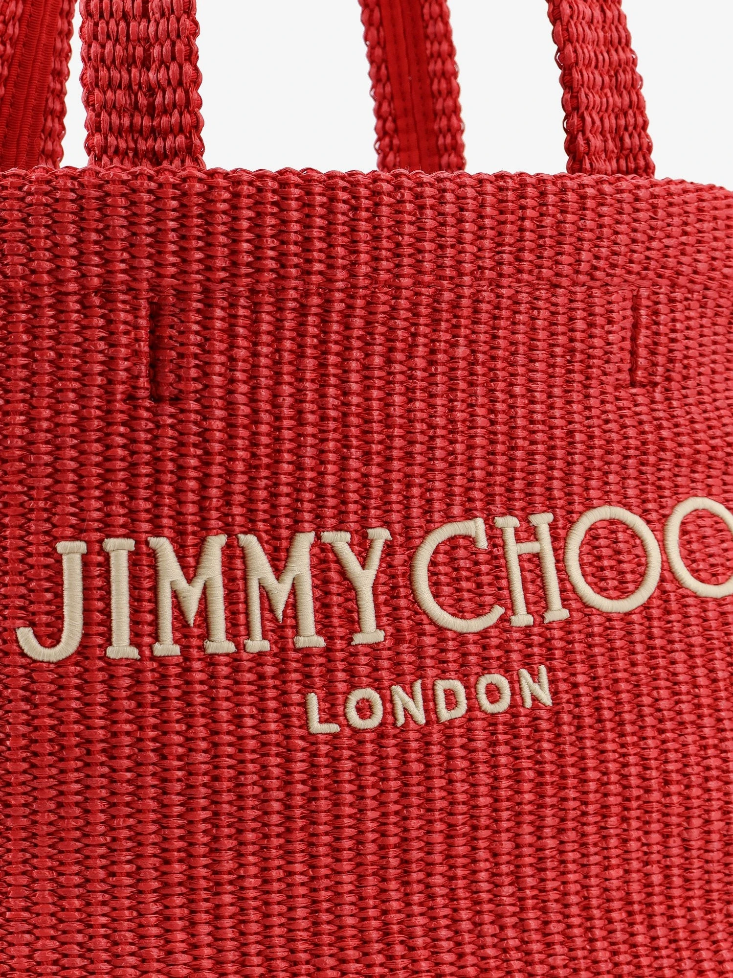 Raffia shopping bag with lettering logo on the front.webp