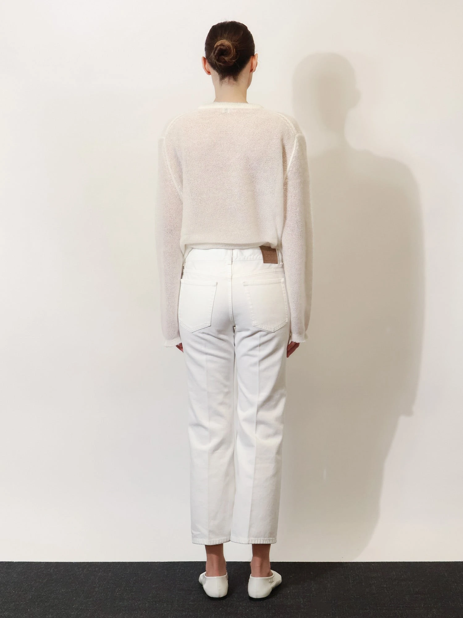 White denim trousers with flared bottom.webp