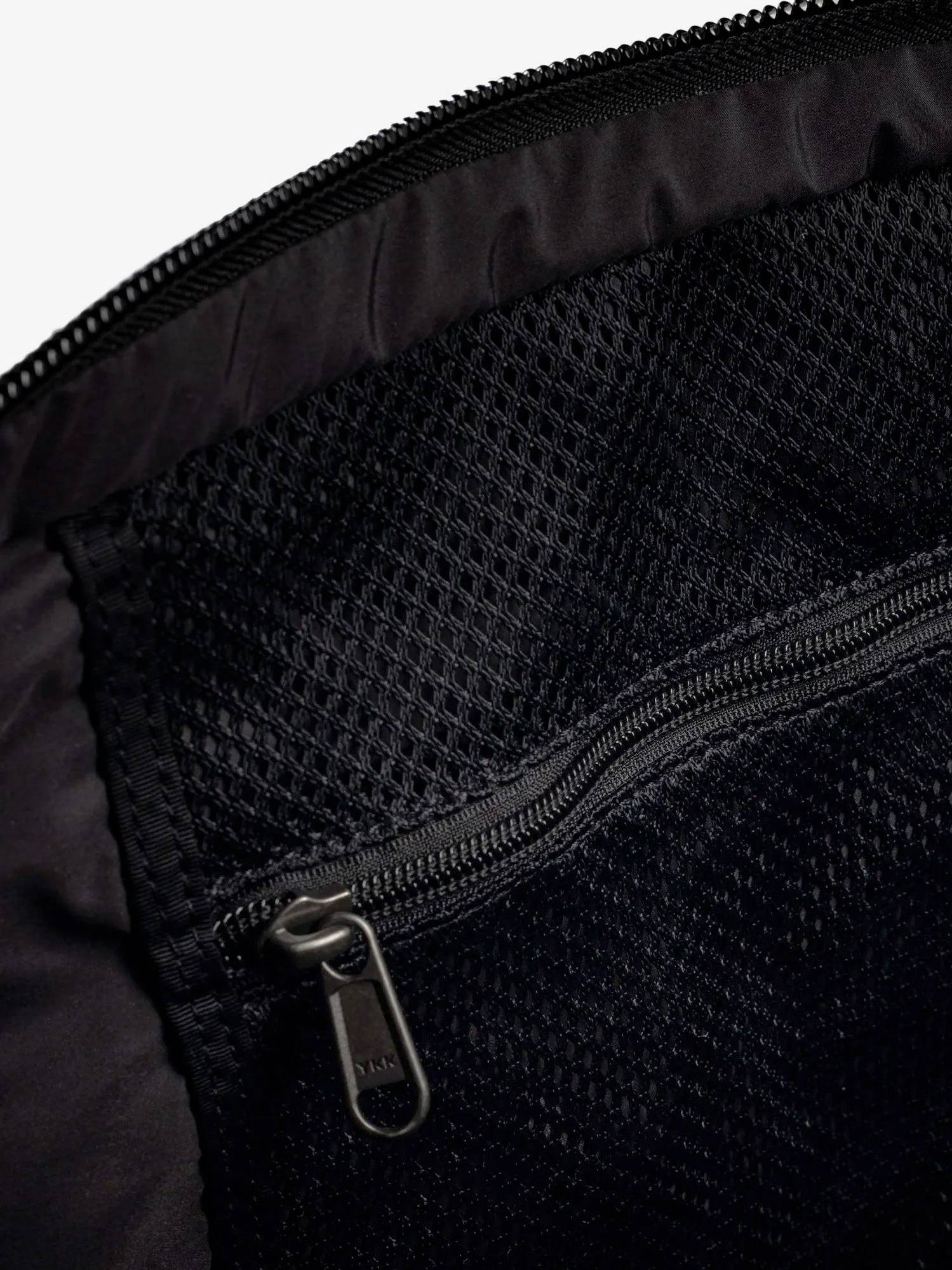 Nylon shoulder bag with logo label on the bottom.webp