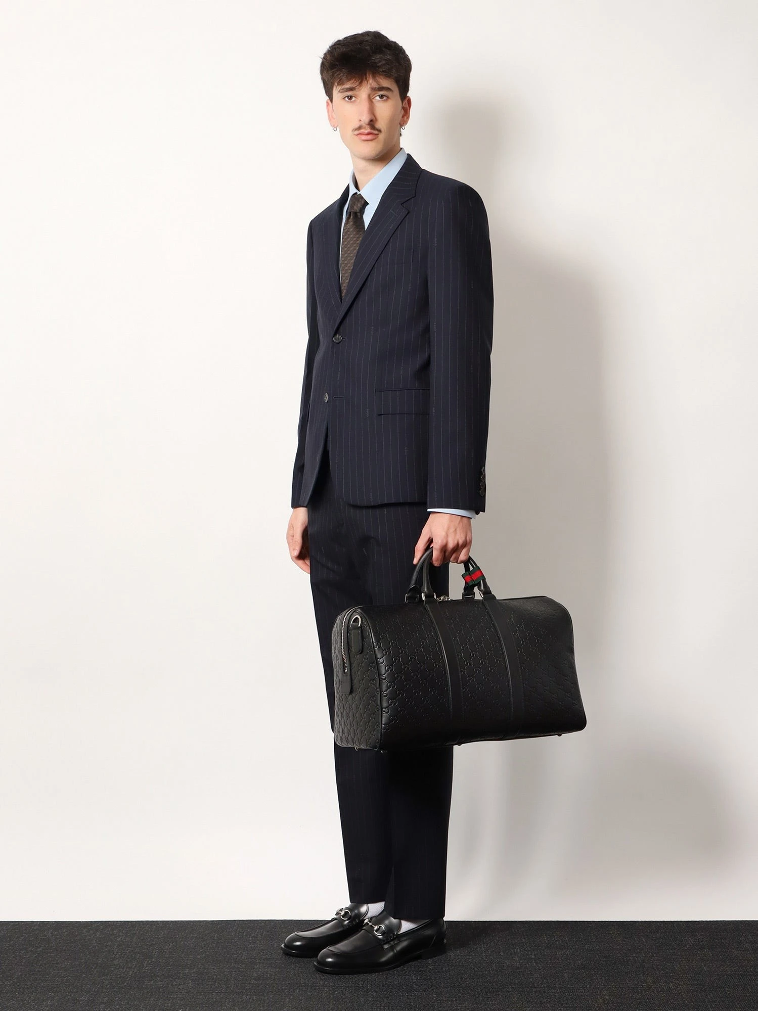 Coated canvas GG Emblem travel bag with GG motif.webp