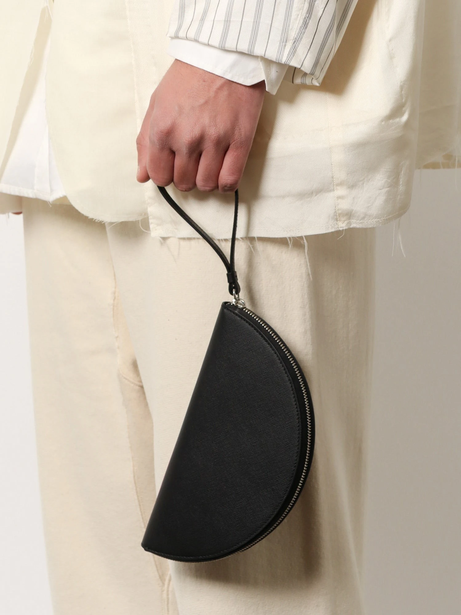 Leather pochette with iconic four stitched detail.webp