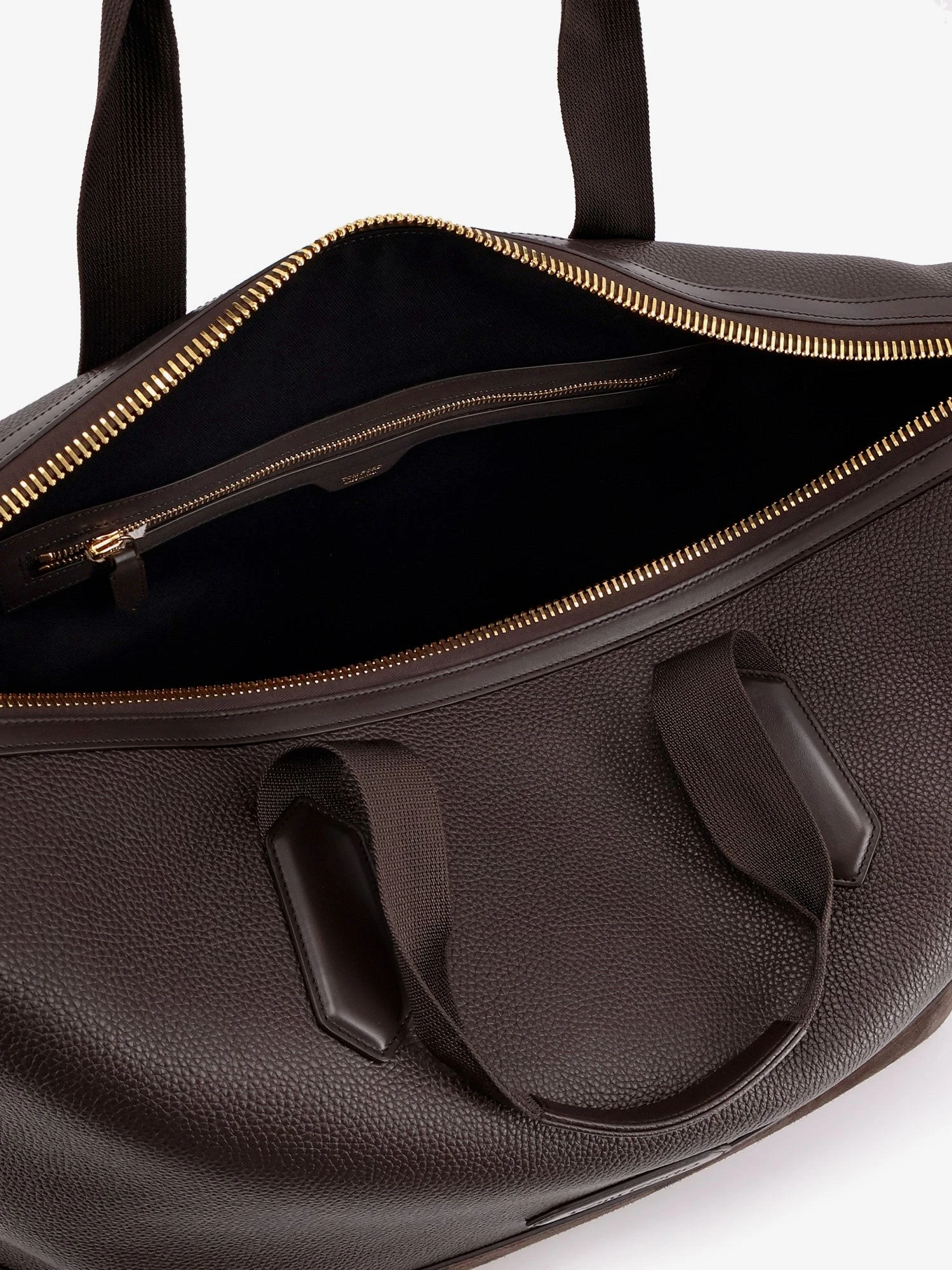 Leather travel bag with suede inserts.webp