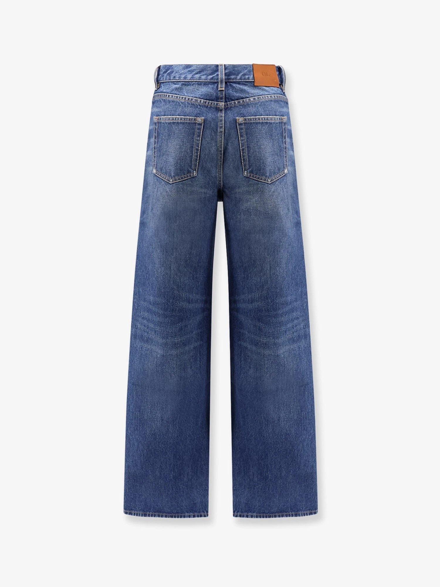 Jeans with leather logo tag.webp