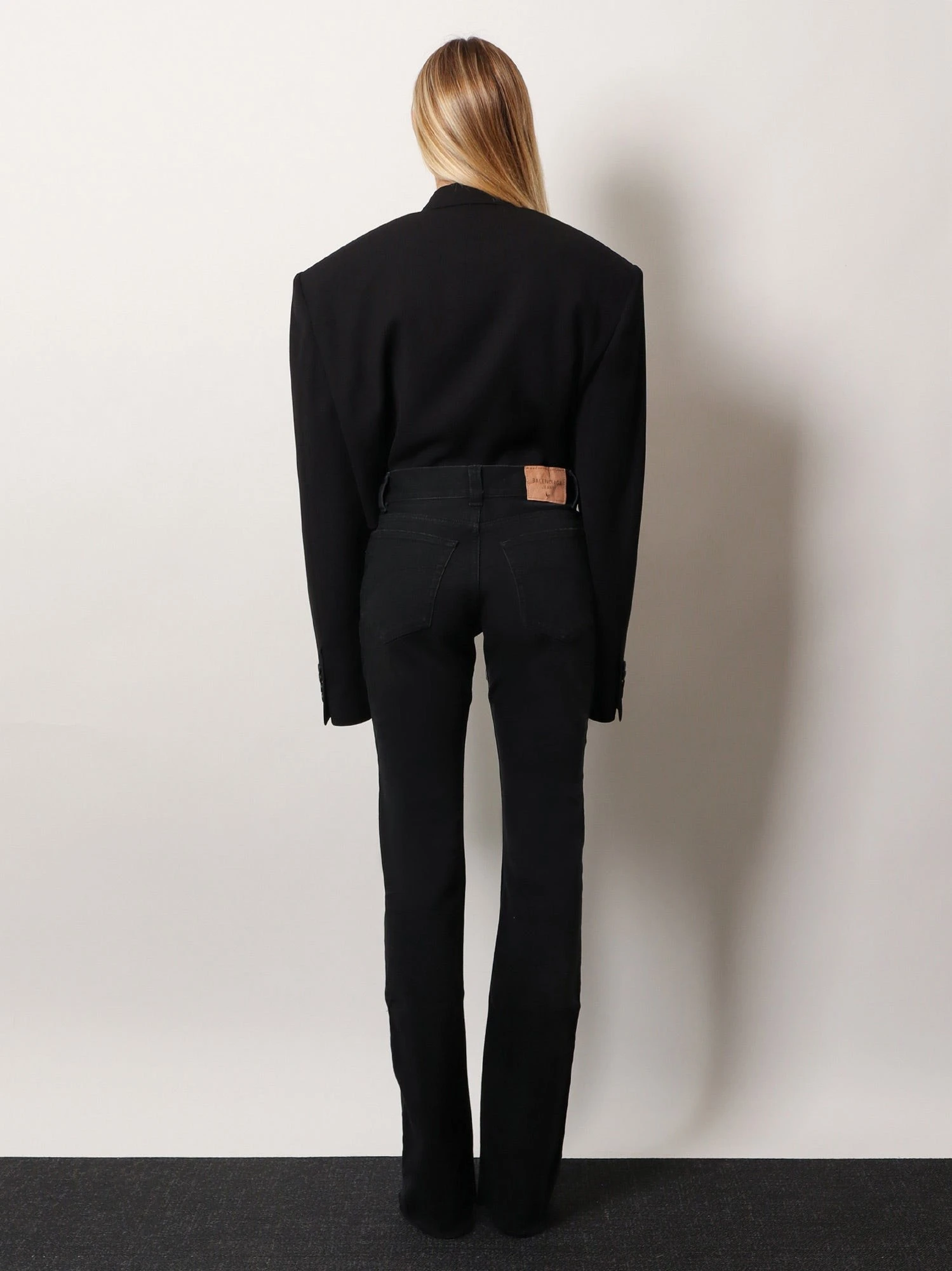 Denim trousers with frayed edges.webp