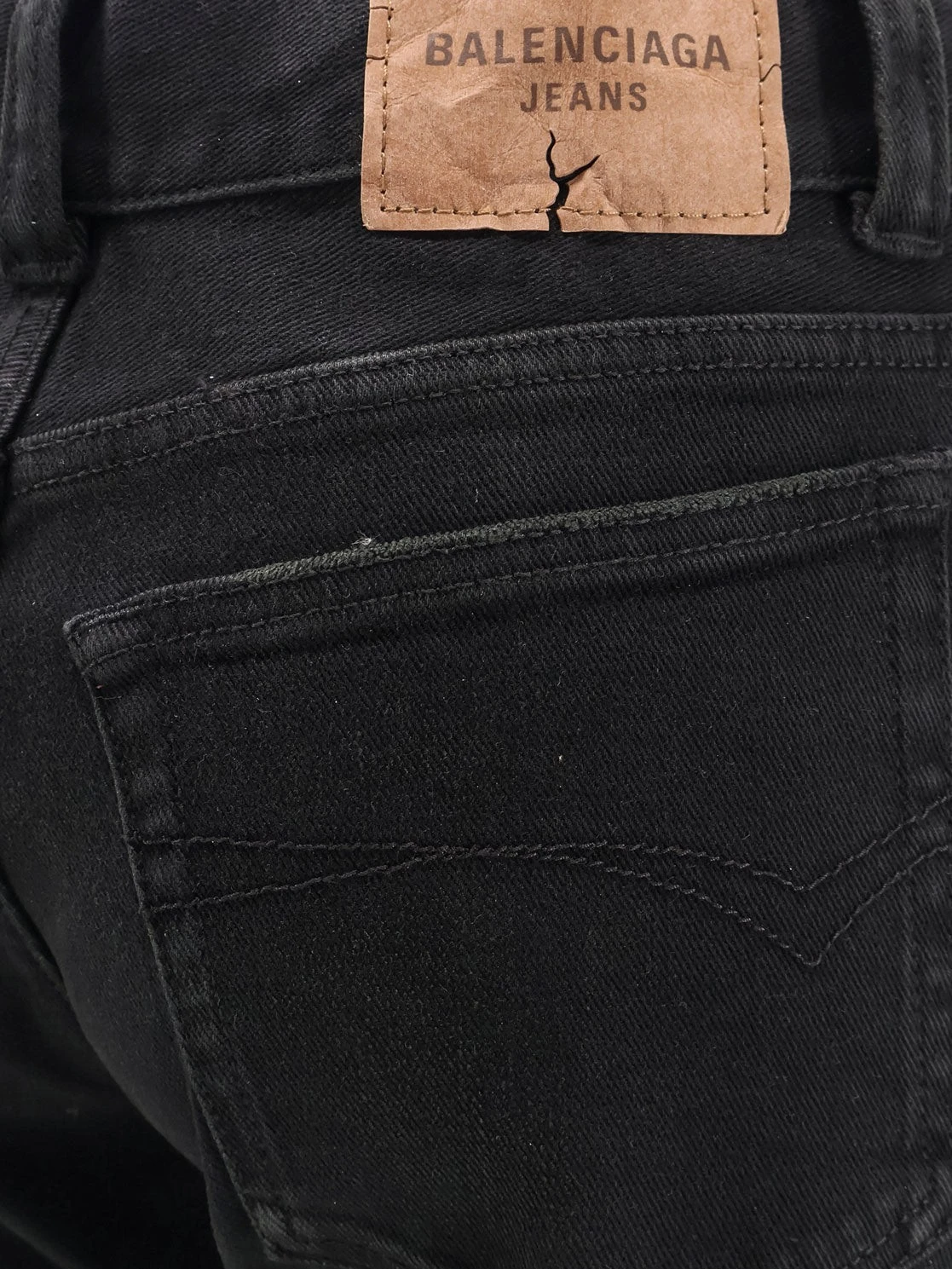 Denim trousers with frayed edges.webp