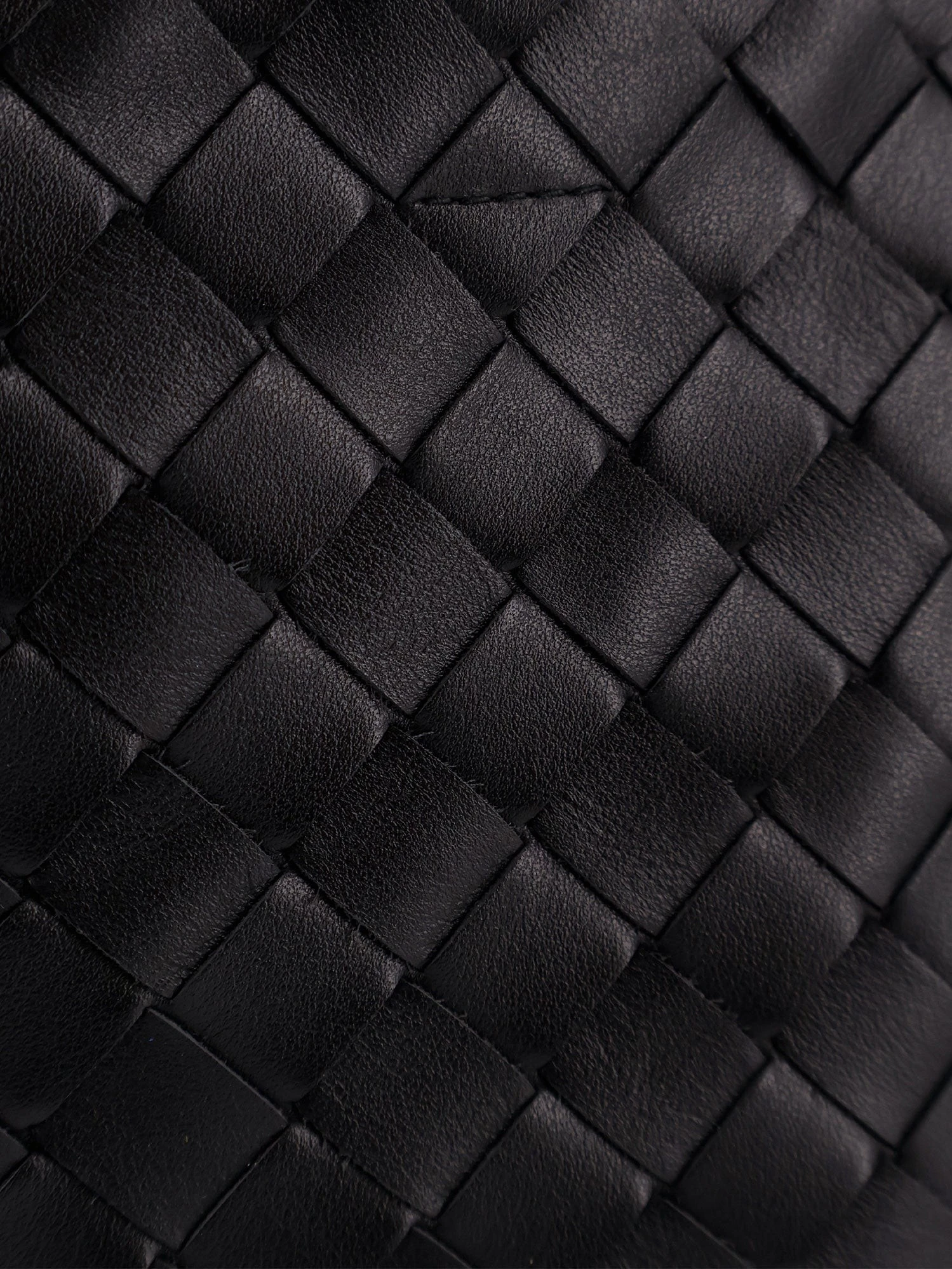 Leather crossbody bag with Intrecciato pattern.webp