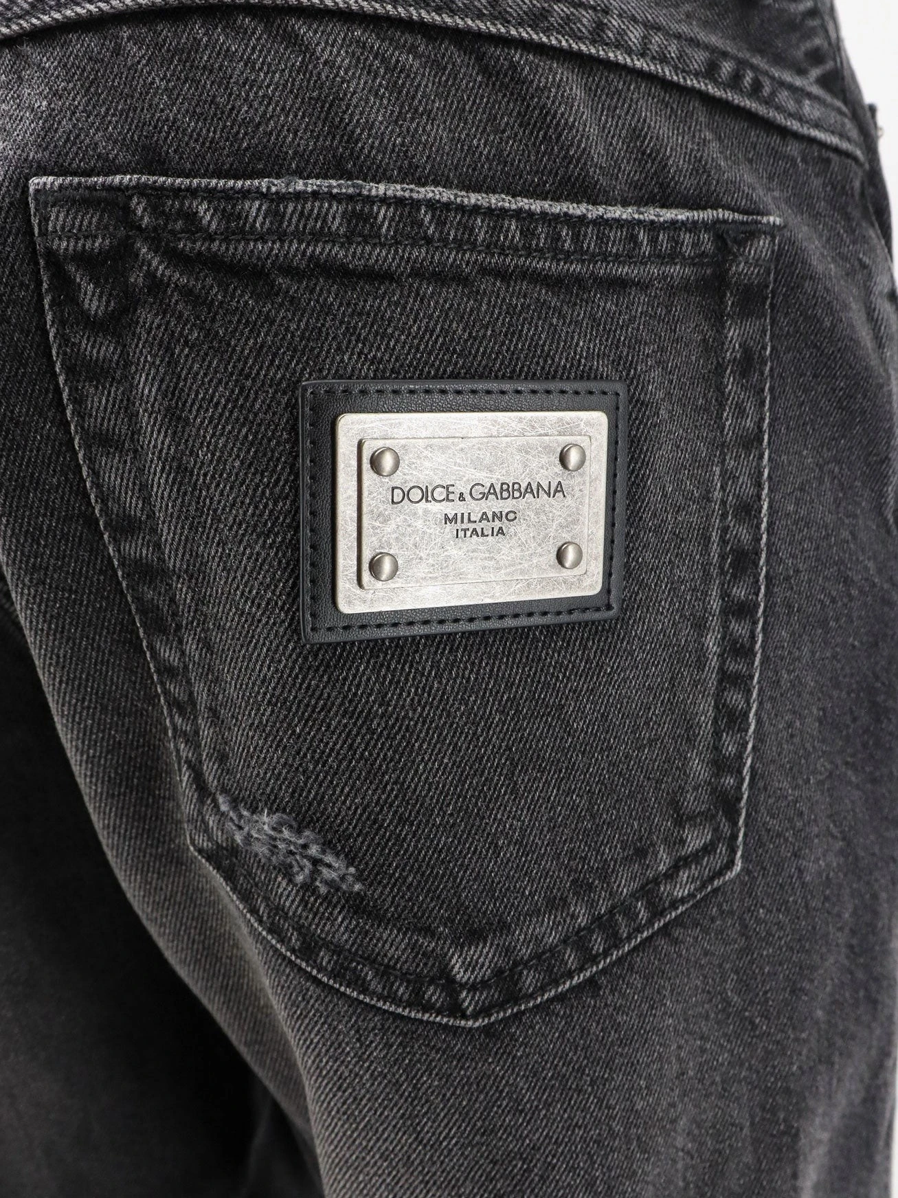 Black denim trousers.webp