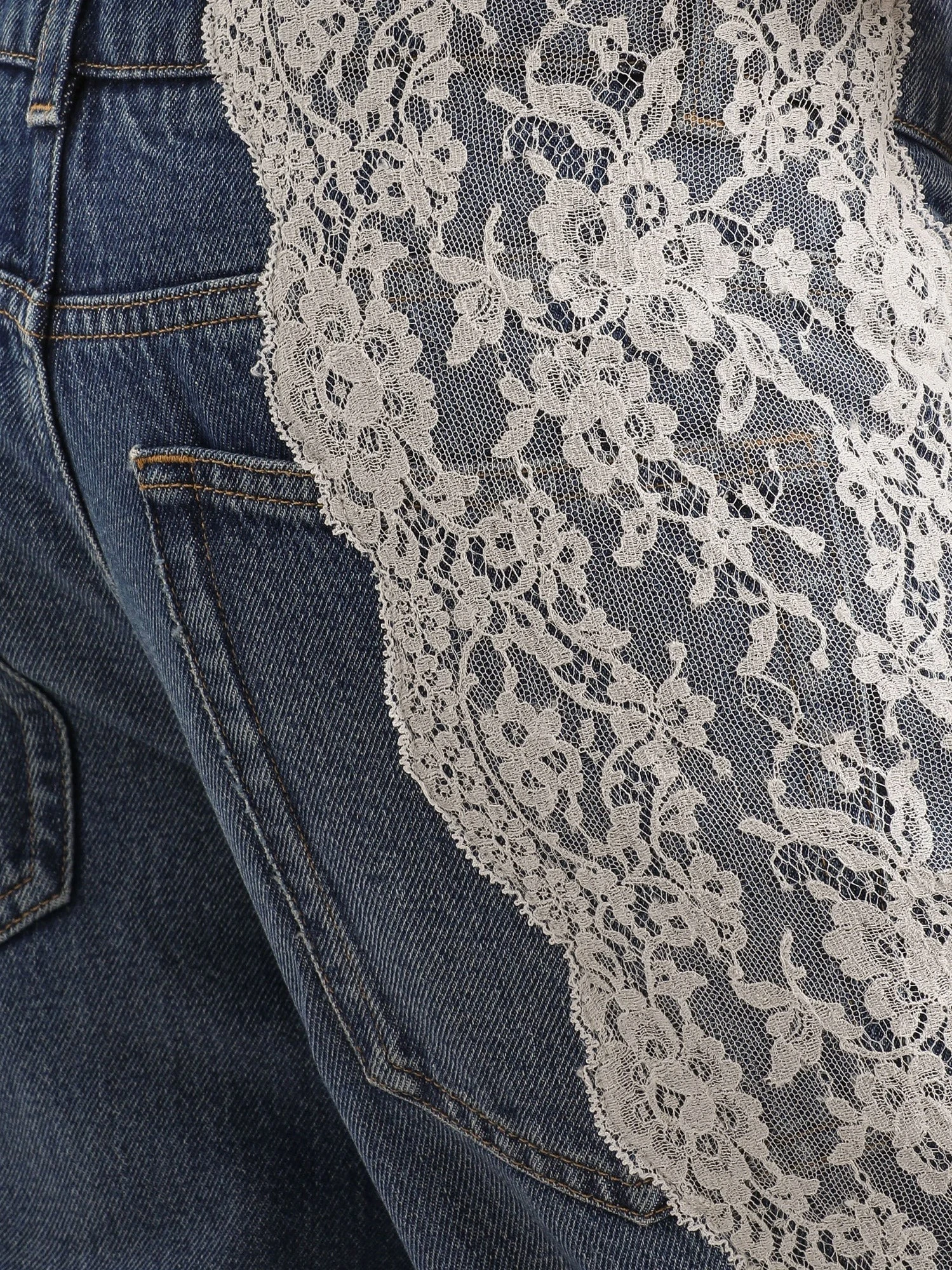 Blue denim jeans with lace profiles.webp