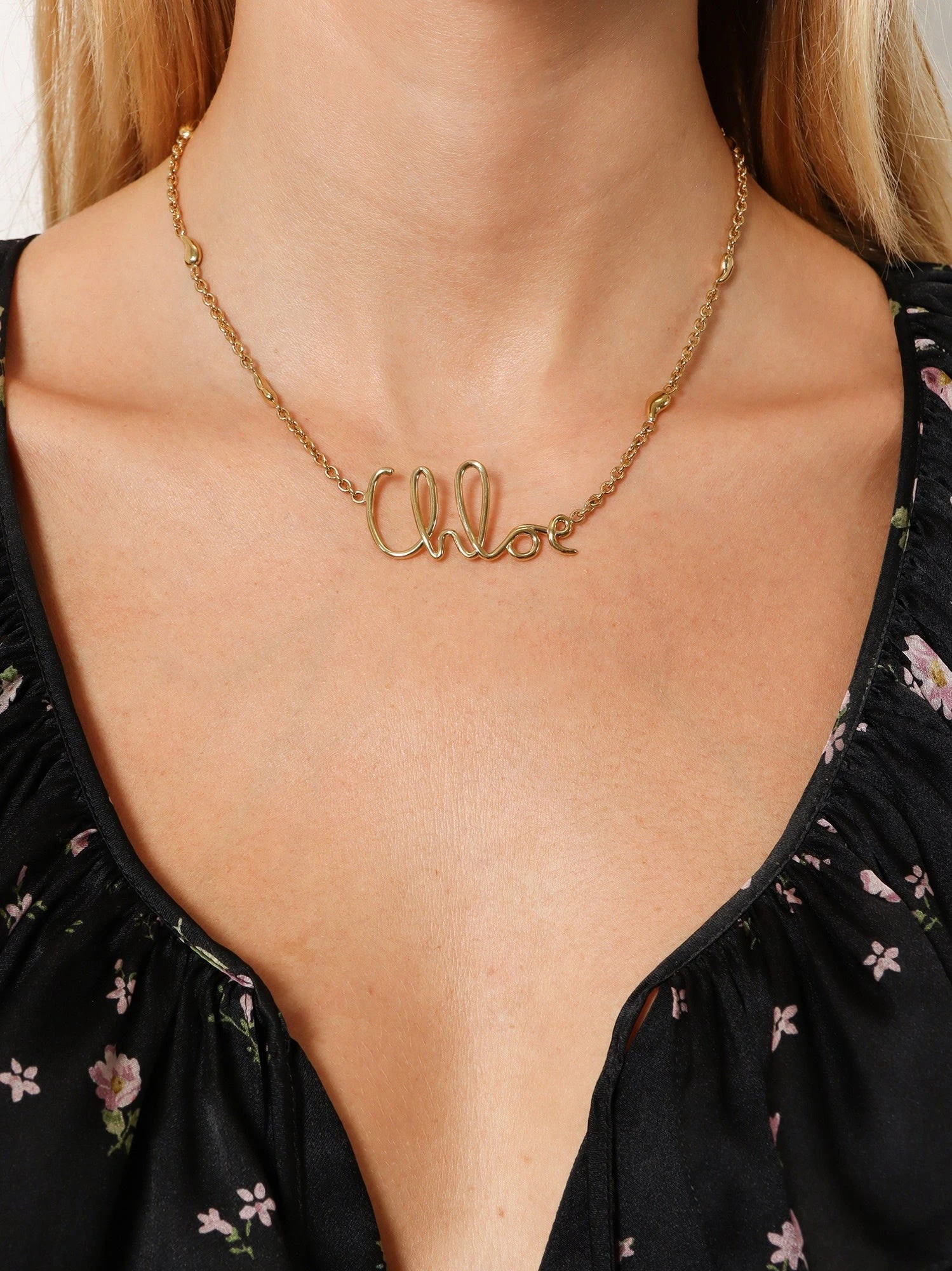 Brass necklace with lettering logo.webp