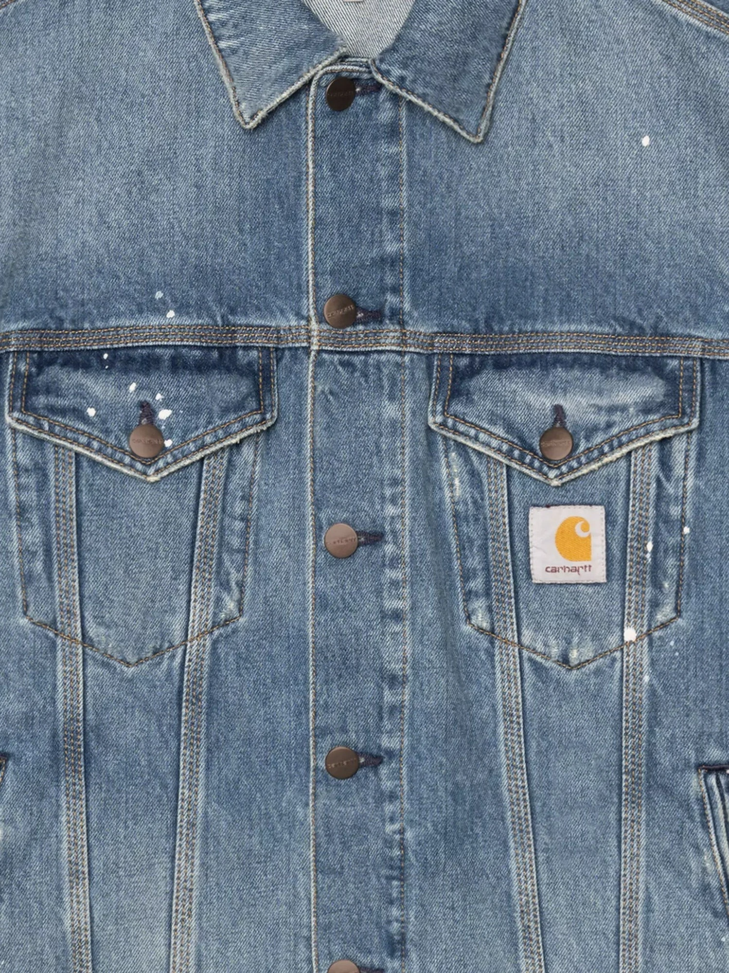 Blue denim jacket with distressed effect.webp