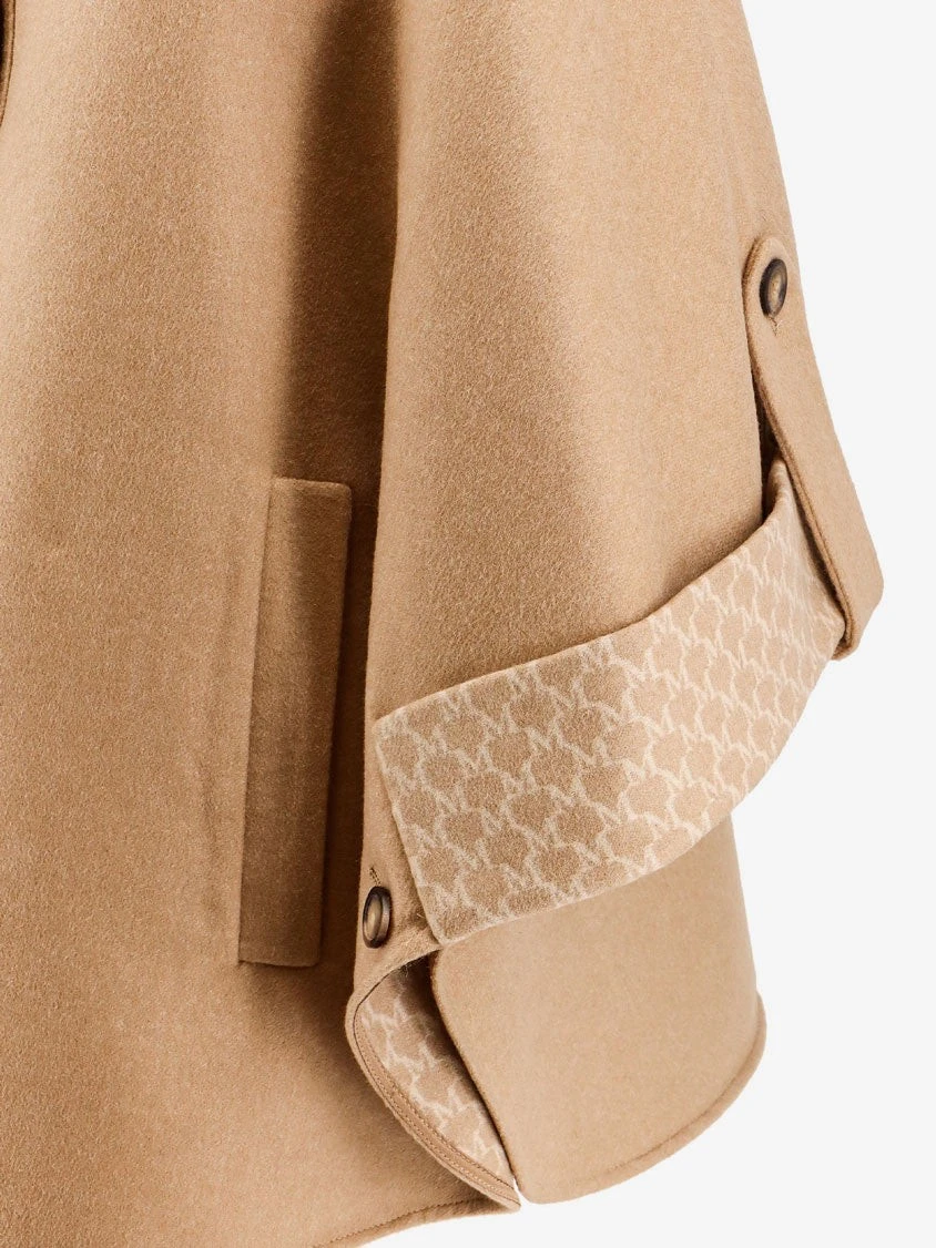 Virgin wool and cashmere cape wih pockets on the front.webp