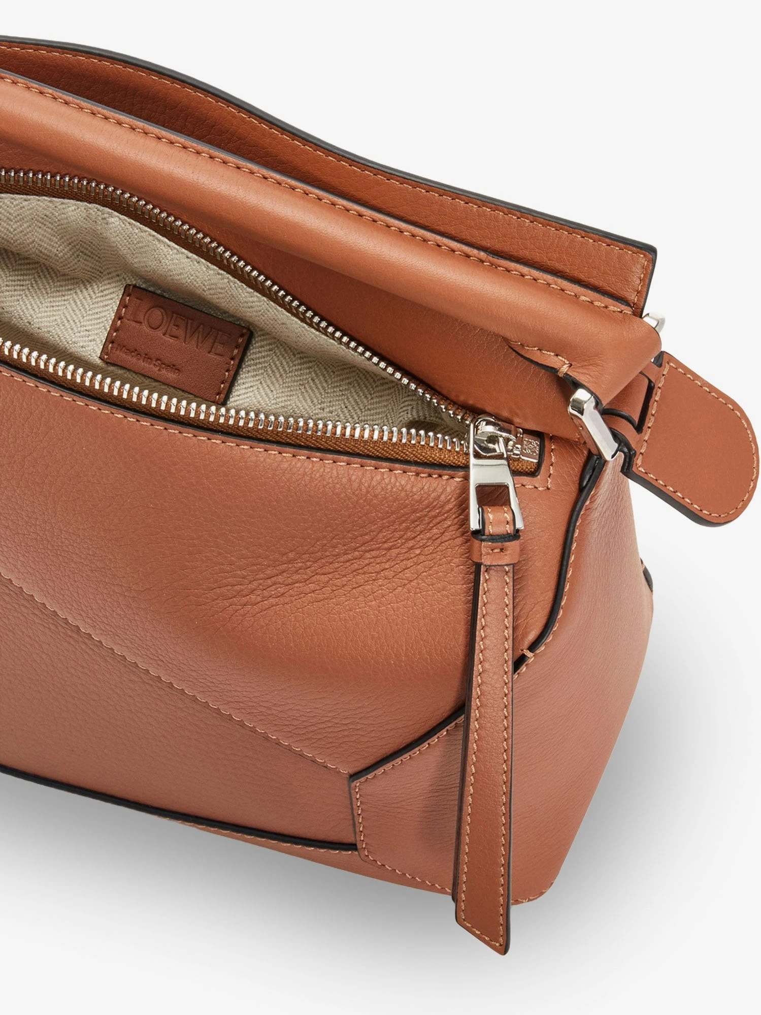 Puzzle Edge leather handbag with engraved Anagram logo.webp