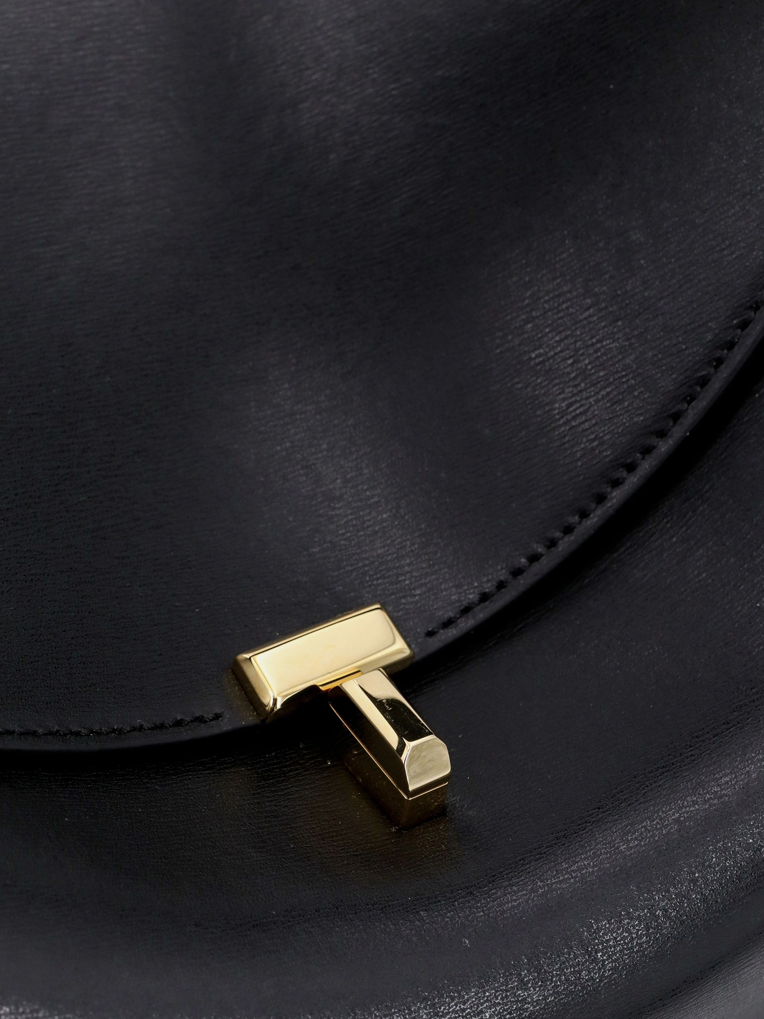 T-Lock leather crossbody bag.webp