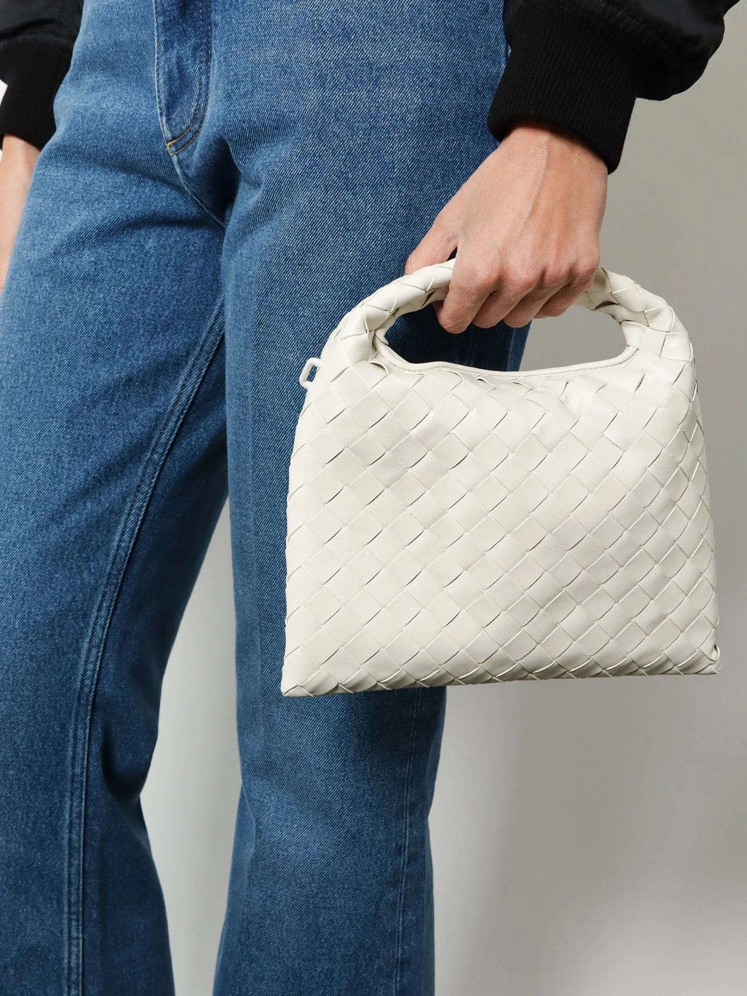 Mini Hop leather crossbody bag with Intrecciato pattern.webp