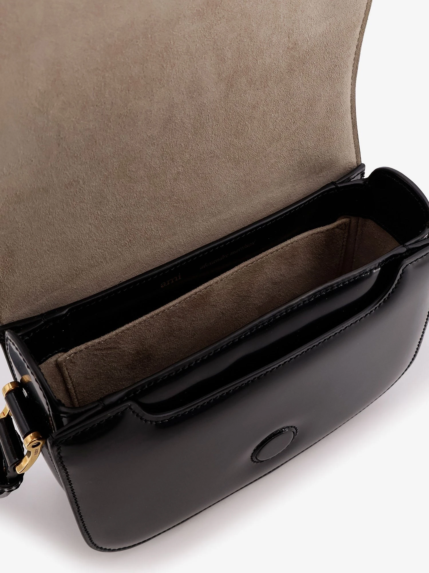Leather shoulder bag with metal logo on the front.webp
