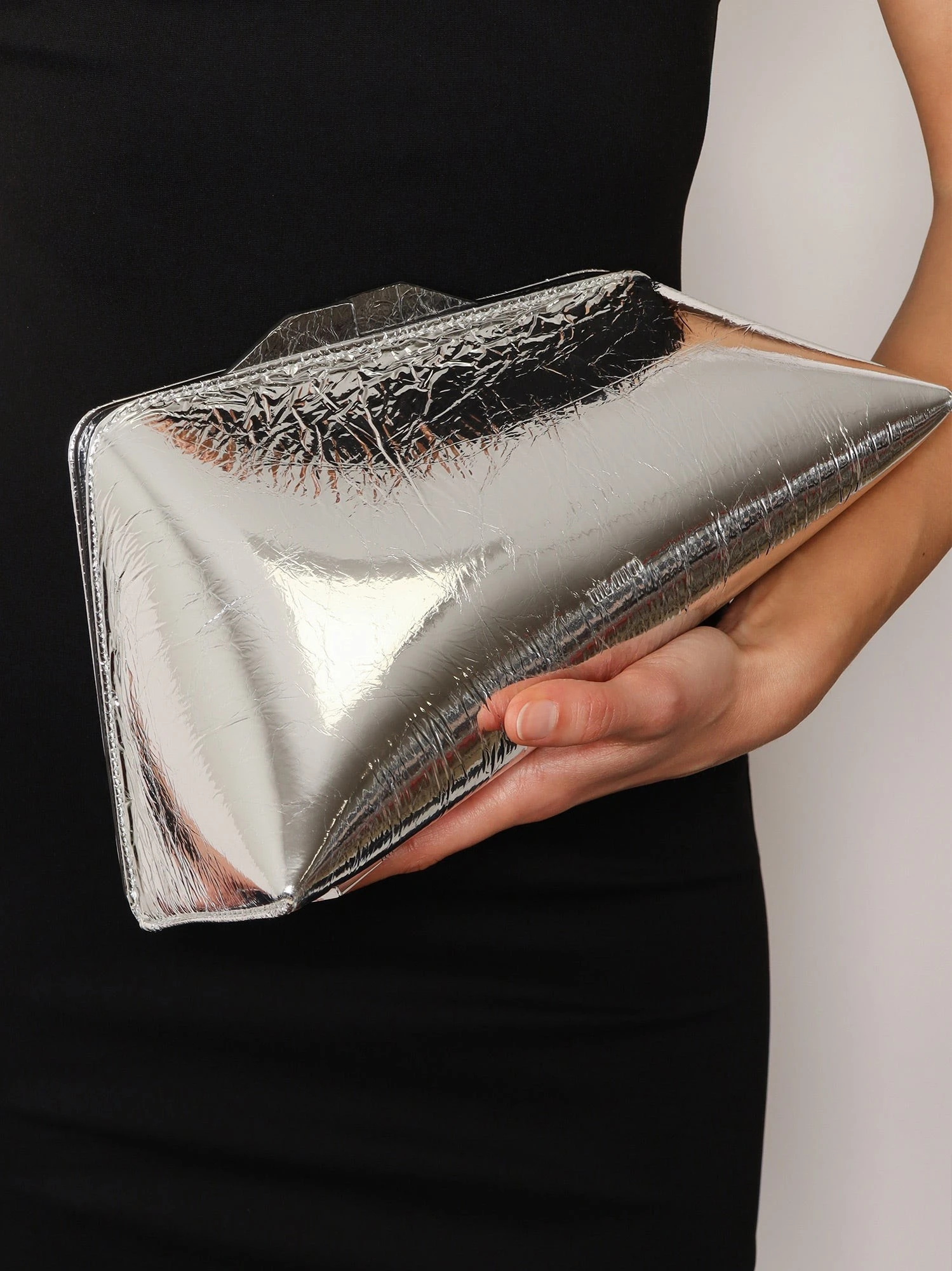 8.30 PM laminated leather clutch bag with logo engraved on the bottom.webp