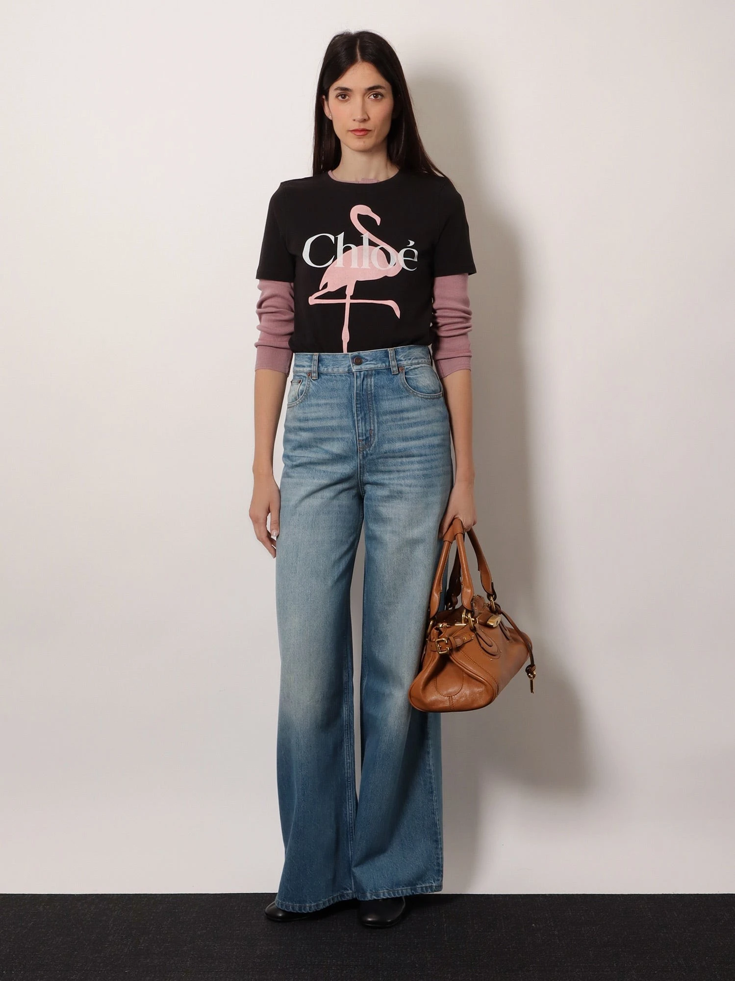 Blue denim jeans with logo label on the back.webp